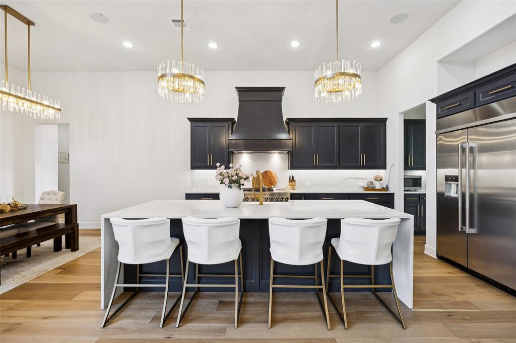 4120 Ridgecrest Drive Flower Mound, TX 75022 - Photo 13 of 40 a large kitchen with a table and chairs
