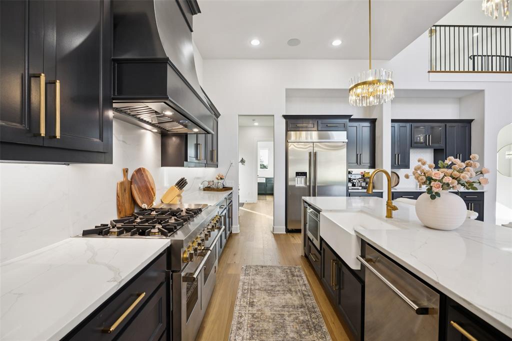 4120 Ridgecrest Drive Flower Mound, TX 75022 - Photo 15 of 40 a kitchen with a sink stove and cabinets