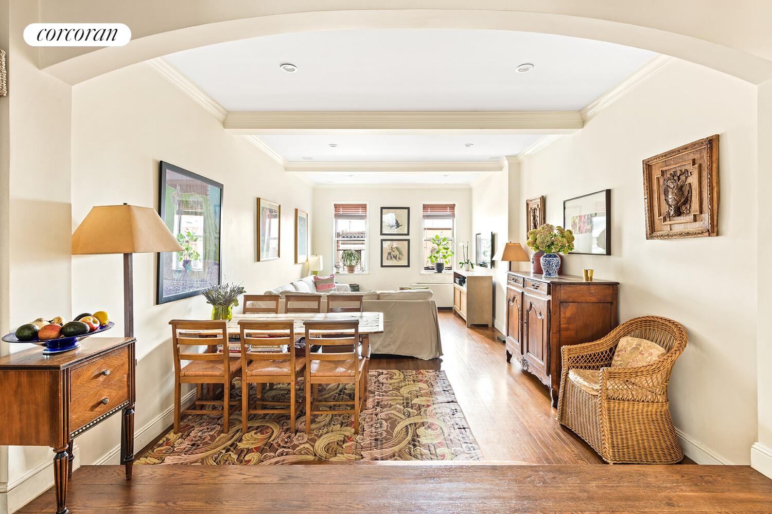 a living room with fireplace furniture and a wooden floor