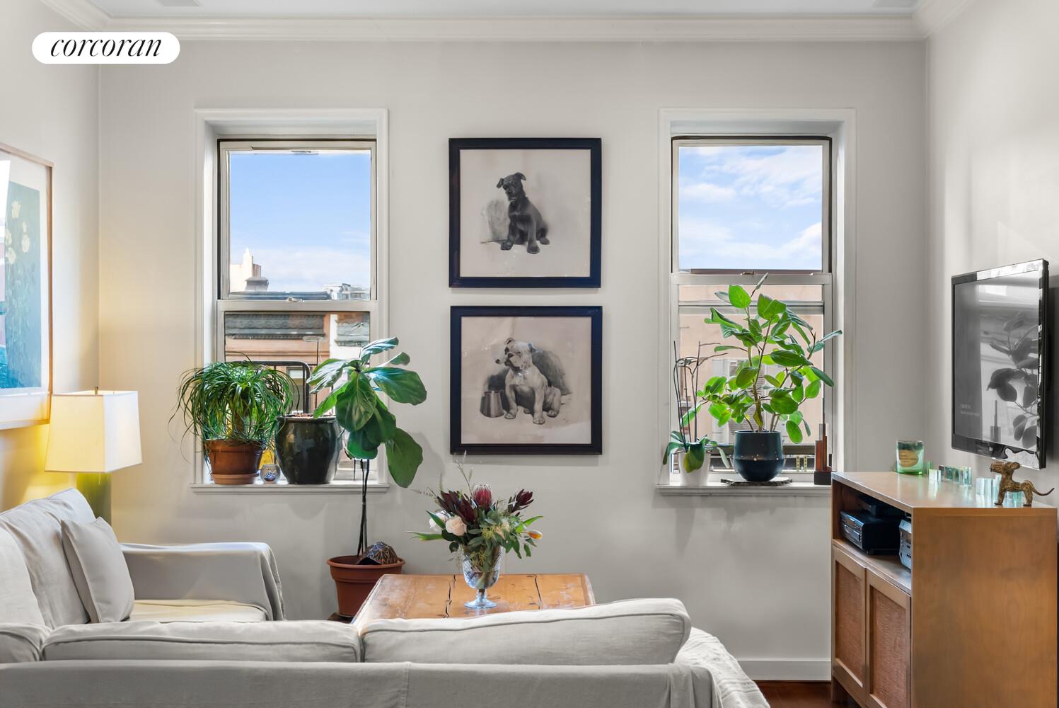 519 East 86th Street, Unit 6D Manhattan, NY 10028 - Photo 3 of 19 a living room with furniture a chandelier and a window