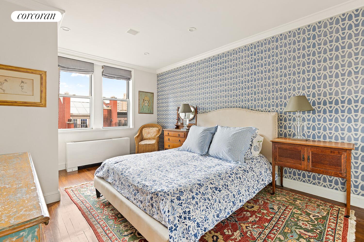 519 East 86th Street, Unit 6D Manhattan, NY 10028 - Photo 6 of 19 a bedroom with a bed and wooden floor