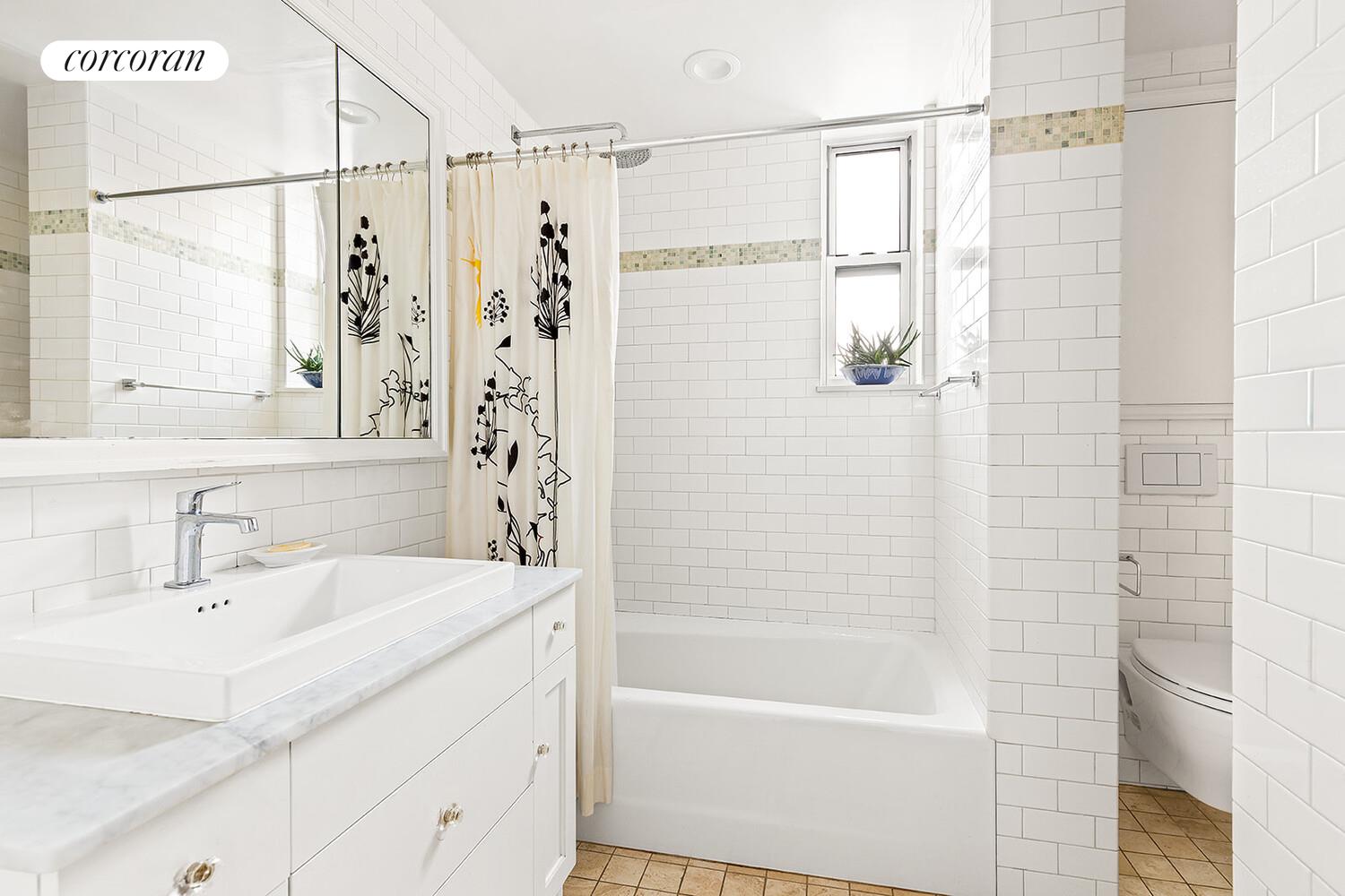 519 East 86th Street, Unit 6D Manhattan, NY 10028 - Photo 7 of 19 a bathroom with a shower curtain and a sink