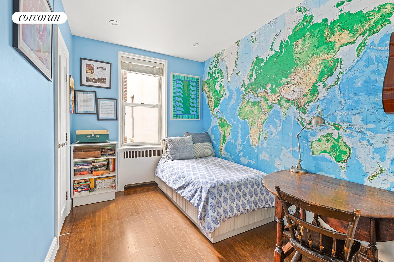 519 East 86th Street, Unit 6D Manhattan, NY 10028 - Photo 9 of 19 a bedroom with a bed and a table in it