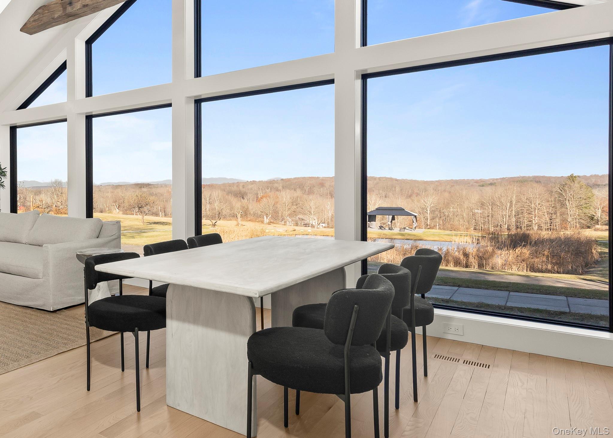 97 Valley Farm Road Millbrook, NY 12545 - Photo 14 of 50 Dining area featuring wood flooring, a view of land, and high vaulted ceiling