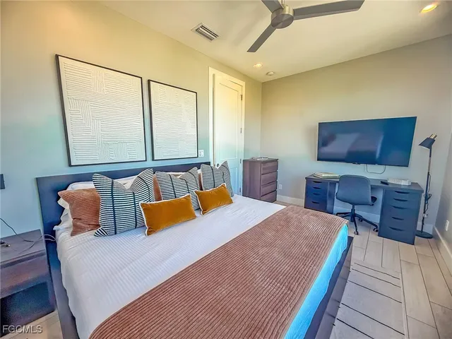 a bedroom with a bed and a large window with the outer view