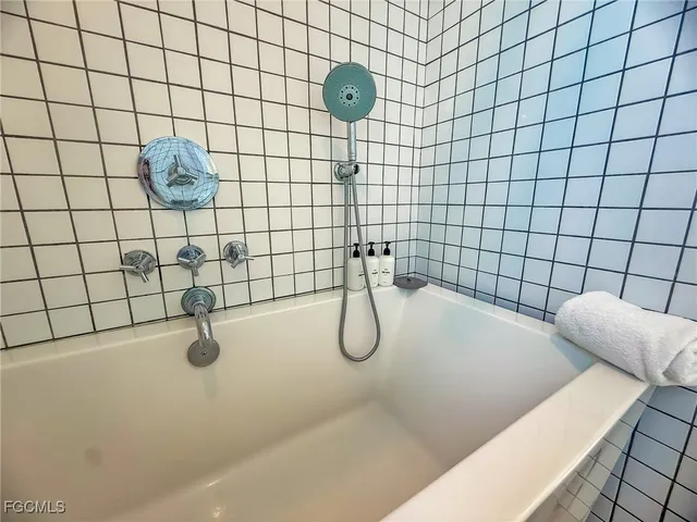 a bathroom with a bathtub and shower