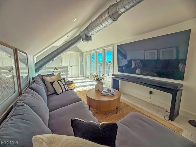 a bedroom with two beds and a large window