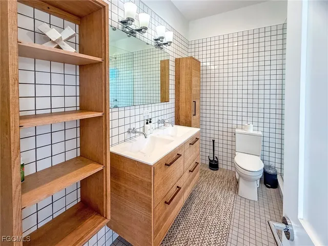 a bedroom with a bed a chandelier and a window