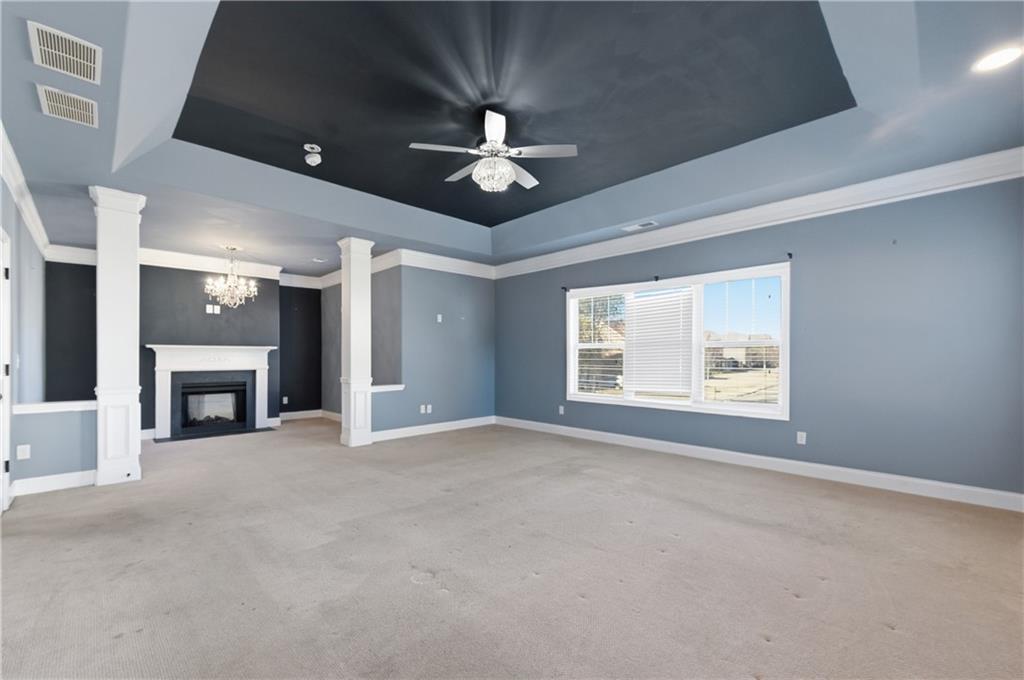 2813 Carrick Court Powder Springs, GA 30127 - Photo 24 of 47 an empty room with windows fireplace and a ceiling fan