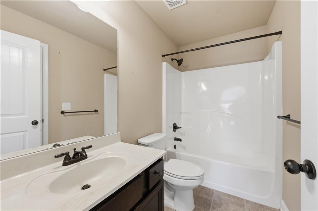2813 Carrick Court Powder Springs, GA 30127 - Photo 32 of 47 a bathroom with a sink mirror toilet and shower