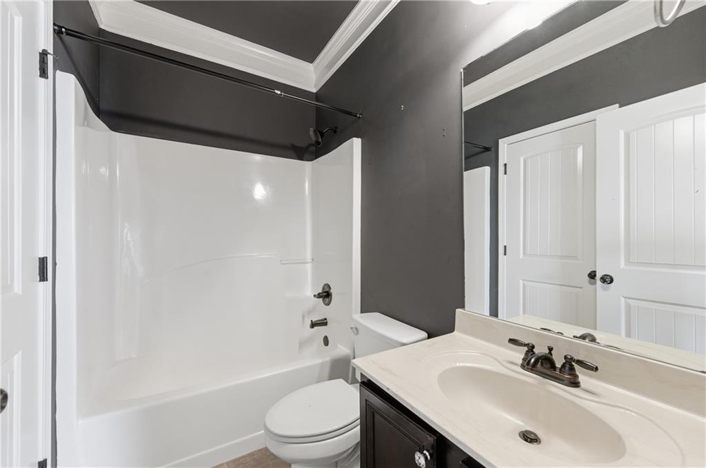 2813 Carrick Court Powder Springs, GA 30127 - Photo 34 of 47 a bathroom with a sink a toilet and shower