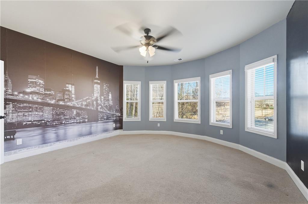 2813 Carrick Court Powder Springs, GA 30127 - Photo 40 of 47 a large room with windows and chandelier fan