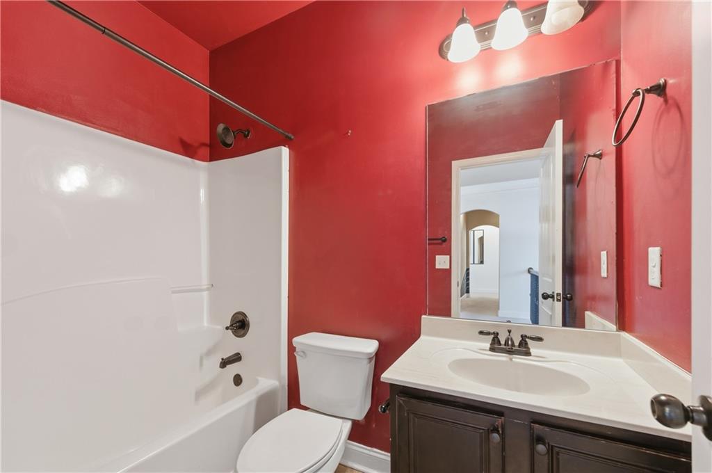 2813 Carrick Court Powder Springs, GA 30127 - Photo 41 of 47 a bathroom with a sink vanity mirror and toilet