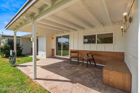 a view of a house with backyard porch and sitting area