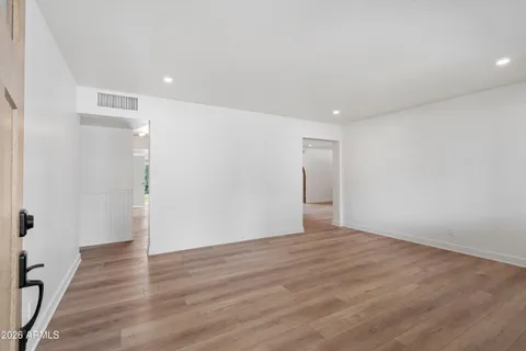 a view of an empty room with wooden floor