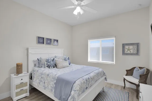 a bedroom with a large bed and a chair