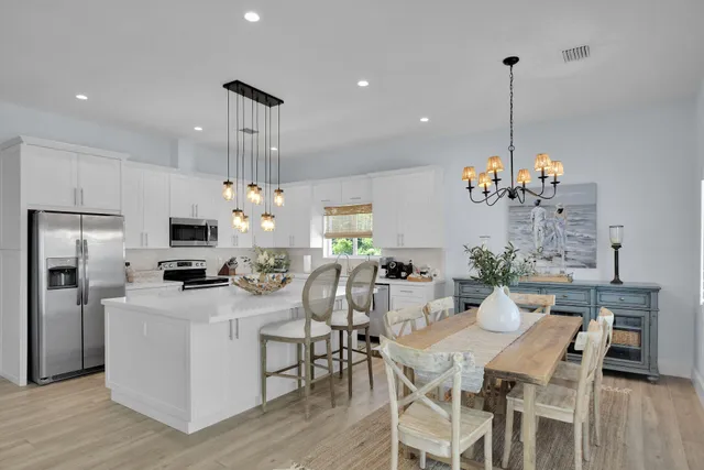 a view of a dining room and chandelier furniture microwave and wooden floor