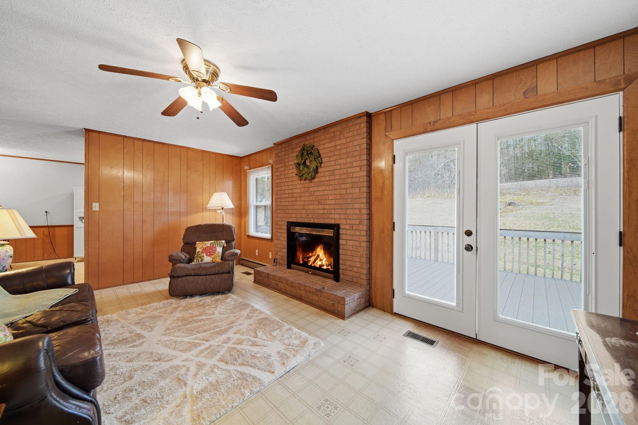 6418 Casar Road Casar, NC 28020 - Photo 18 of 38 a living room with furniture a fireplace and a flat screen tv