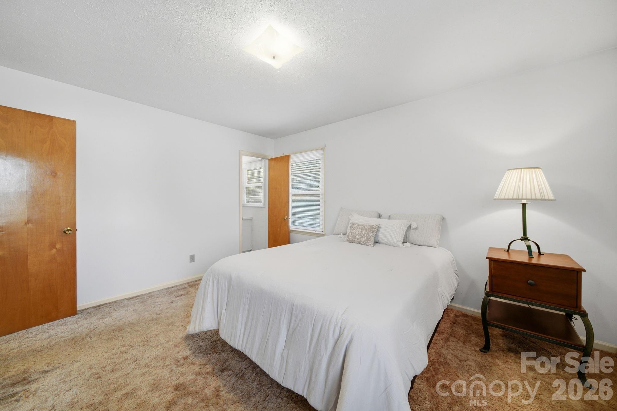 6418 Casar Road Casar, NC 28020 - Photo 31 of 38 a bedroom with a bed and a lamp on table
