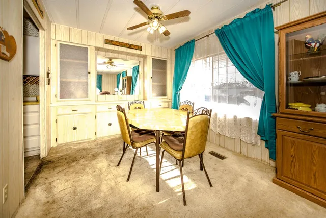 a dining room with furniture and a window