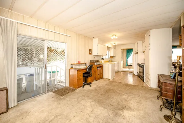 a bedroom with a bed and dresser with mirror