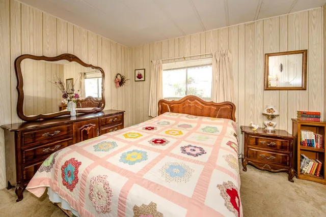 a bedroom with a bed and a dresser