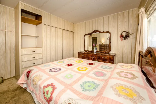 a bedroom with a bed and a closet