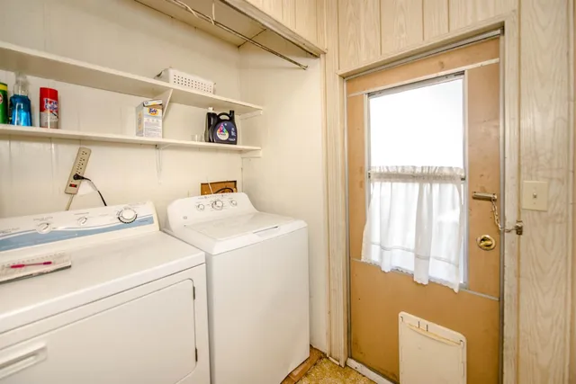 a view of a hallway with bathroom and glass door