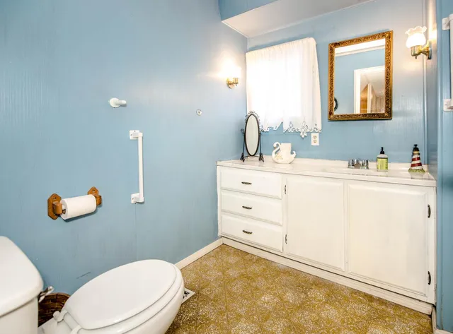 a large bed sitting in a bedroom next to a window