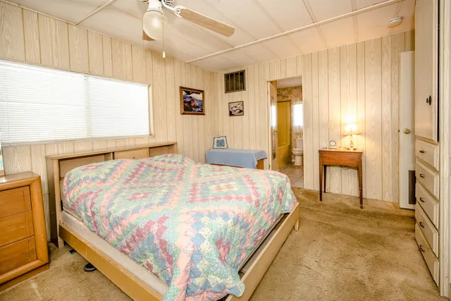 a bedroom with a bed and window