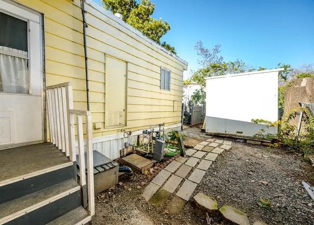 a view of a house with a wooden deck