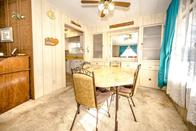 a dining room with furniture and a floor to ceiling window