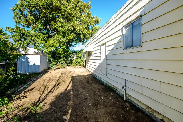 a view of a swimming pool with a garden and plants