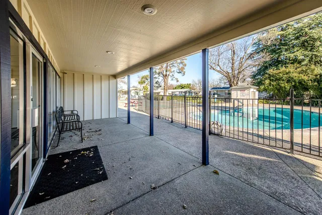 a view of a patio with a table and chairs