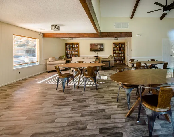 a yard with red and white house