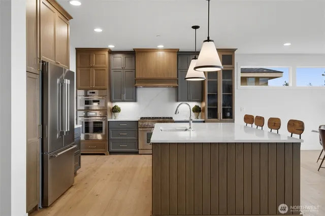 a kitchen with center island white cabinets and couches