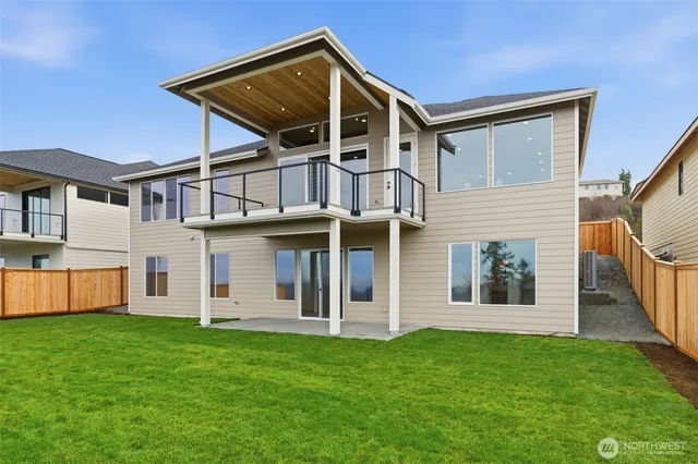 a front view of a house with a garden and yard