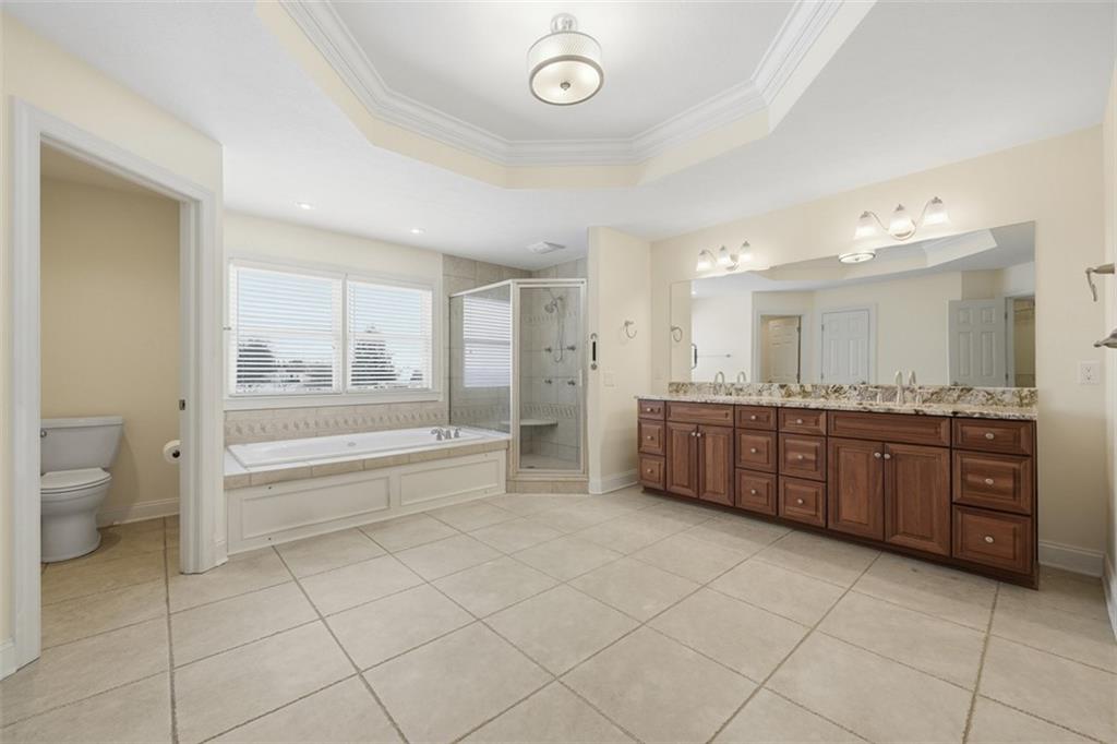 110 Timber Ridge Drive Harmony, PA 16037 - Photo 22 of 50 a spacious bathroom with a granite countertop toilet a sink and a bathtub