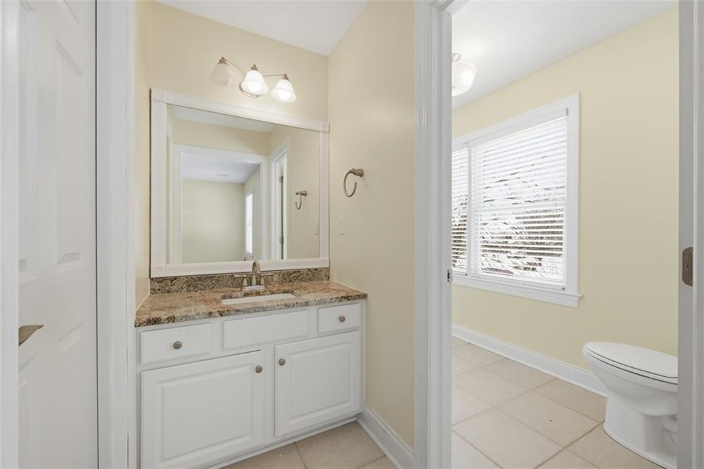 110 Timber Ridge Drive Harmony, PA 16037 - Photo 31 of 50 a bathroom with a granite countertop sink toilet a large mirror a vanity and next to a window