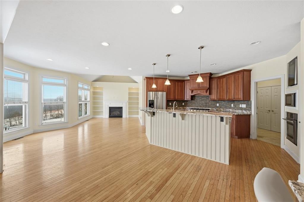 110 Timber Ridge Drive Harmony, PA 16037 - Photo 5 of 50 a view of a kitchen with kitchen island wooden floors center island and stainless steel appliances
