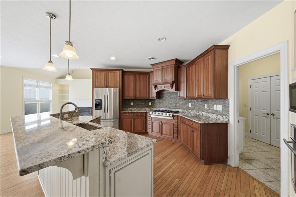 110 Timber Ridge Drive Harmony, PA 16037 - Photo 6 of 50 a kitchen with granite countertop kitchen island stainless steel appliances a sink stove and refrigerator