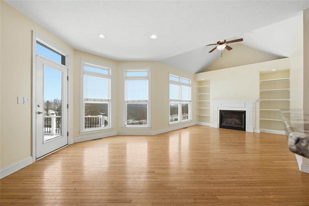 110 Timber Ridge Drive Harmony, PA 16037 - Photo 9 of 50 a view of a livingroom with wooden floor and a fireplace