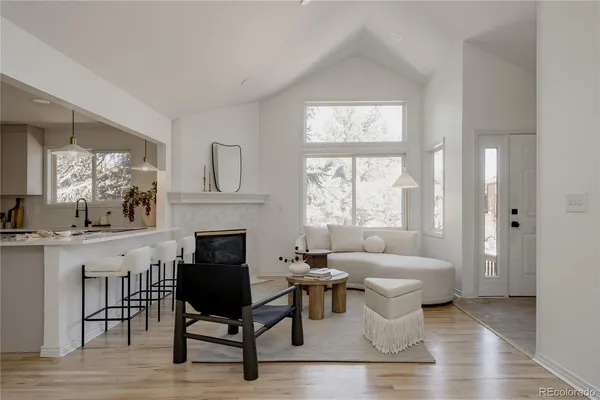 a living room with furniture a fireplace and a table