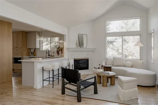 a living room with furniture a window and a fireplace