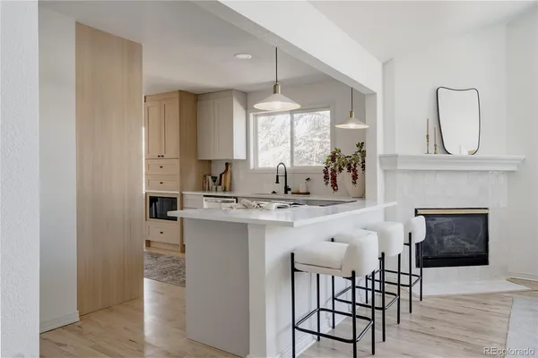 a kitchen with stainless steel appliances granite countertop a kitchen island a stove a cabinets and a chandelier