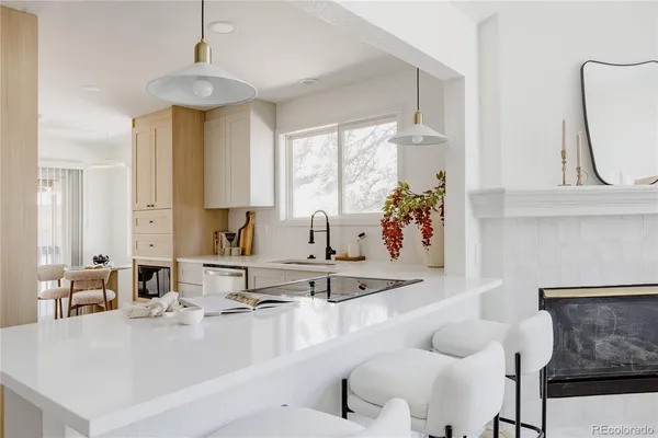 a kitchen with granite countertop a sink and a stove