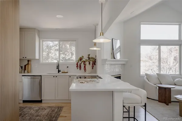 a kitchen with a table chairs refrigerator and window