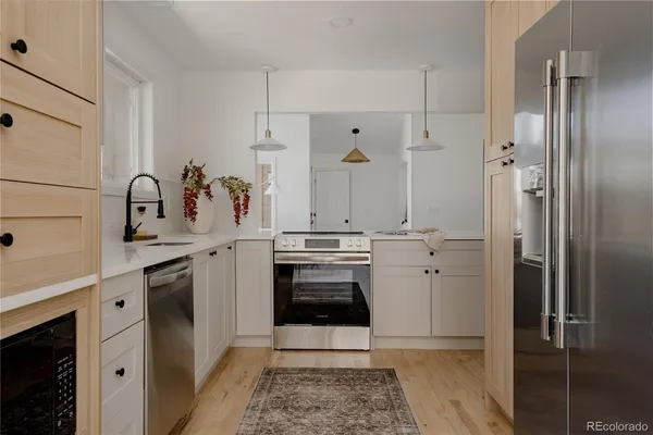 a kitchen with a sink and a refrigerator