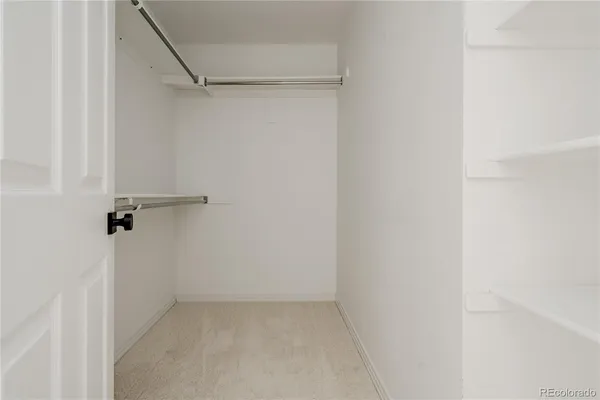 an empty room with a windows and ceiling fan