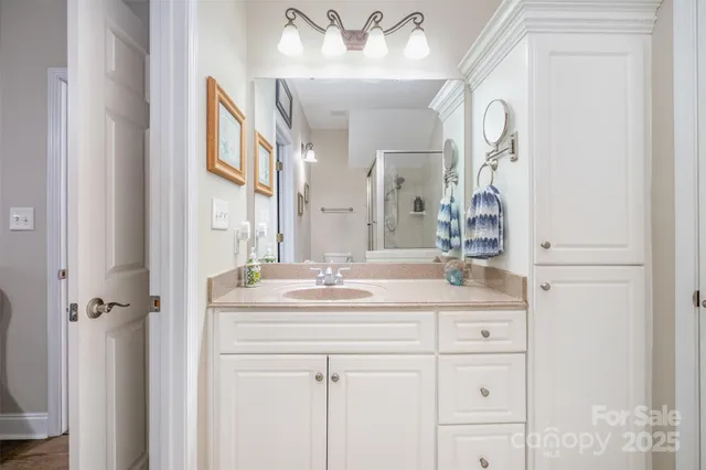 a bathroom with a sink vanity and a mirror